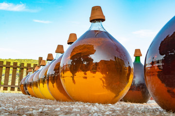 Making of natural sweet dessert muscat liqueur white wine outside in big round glass antique demijohn bottles in Frontignan, south of France
