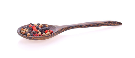Mixed Red, Black and White Peppercorn in Wooden Spoon on white background.