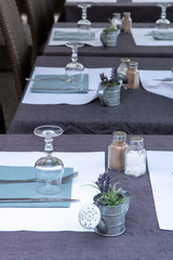 Empty cosy french street cafe or brasserie located on small river with served tables ready for visitors