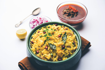 Aloo/Kanda Poha or Tarri Pohe with spicy chana masala/curry. selective focus