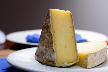 Pieces of French Tomme and Cantal cheese, close up