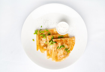 Crepes Suzette sour cream on white plate over white background, copy space. Delicious homemade Crepes for breakfast. - Image