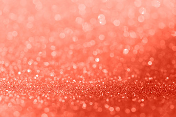 Living coral color bokeh glitter background texture