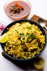 Aloo/Kanda Poha or Tarri Pohe with spicy chana masala/curry. selective focus