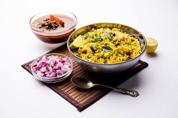 Aloo/Kanda Poha or Tarri Pohe with spicy chana masala/curry. selective focus