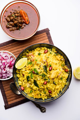 Aloo/Kanda Poha or Tarri Pohe with spicy chana masala/curry. selective focus