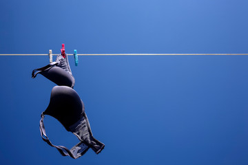 black bra drying on a washing line