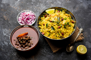 Aloo/Kanda Poha or Tarri Pohe with spicy chana masala/curry. selective focus