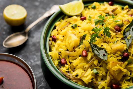 Aloo/Kanda Poha or Tarri Pohe with spicy chana masala/curry. selective focus