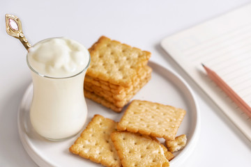 Yogurt and cookies is a healthy breakfast. Yogurt made from milk fermented by added bacteria, often sweetened and flavored.