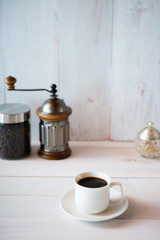cup of coffee and beans on white background