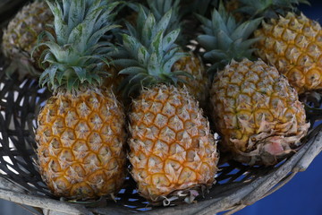 On the counter in the basket are pineapples