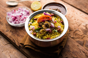 Aloo/Kanda Poha or Tarri Pohe with spicy chana masala/curry. selective focus