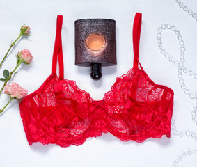 red bra and perfume on white background