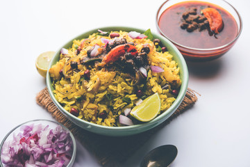 Aloo/Kanda Poha or Tarri Pohe with spicy chana masala/curry. selective focus