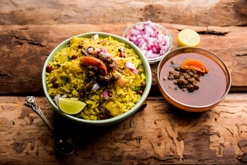 Aloo/Kanda Poha or Tarri Pohe with spicy chana masala/curry. selective focus