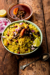 Aloo/Kanda Poha or Tarri Pohe with spicy chana masala/curry. selective focus