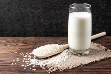 Rice milk on wooden background.