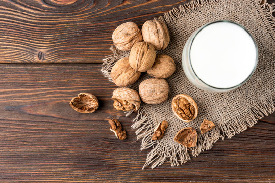 Walnut Milk On Wooden Background.