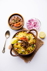 Aloo/Kanda Poha or Tarri Pohe with spicy chana masala/curry. selective focus