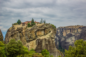 Asian old lonely monastery on top of steep rock in highland mountain landscaping picturesque environment in cloudy foggy weather, pilgrimage concept wallpaper pattern photography, copy space