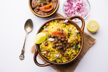 Aloo/Kanda Poha or Tarri Pohe with spicy chana masala/curry. selective focus
