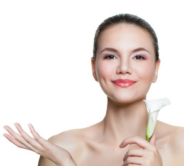 Healthy woman with clear skin and flower showing empty copy space on the open hand isolated on white background. Skin care and spa concept
