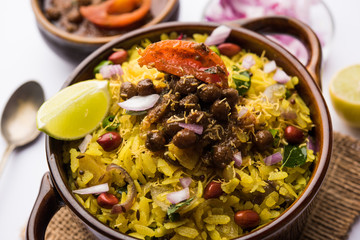 Aloo/Kanda Poha or Tarri Pohe with spicy chana masala/curry. selective focus