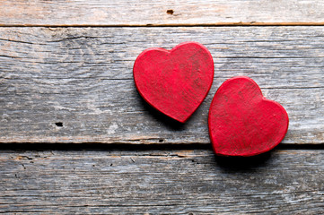 Hand-made symbols in the shape of a heart on wood.