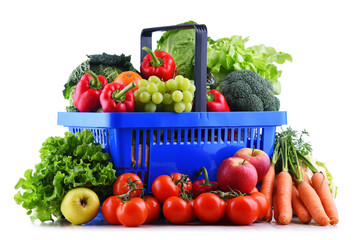 Fresh organic fruits and vegetables in plastic shopping basket