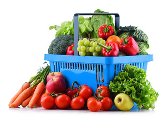 Fresh organic fruits and vegetables in plastic shopping basket