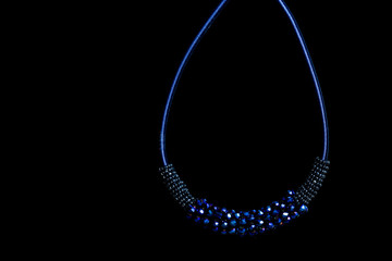 Blue pendant with crystals on black background