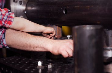 good father took his little son to work with metal. Concept of relationship, child at work turner