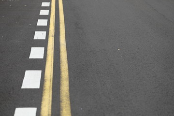 Close up straight and smooth asphalt road with one continuous marking