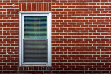 window with shutters and old brick wall