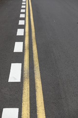 Close up straight and smooth asphalt road with one continuous marking