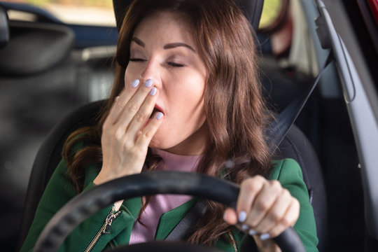 Woman Yawning Inside Car