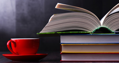 Composition with books and cup of coffee on the table