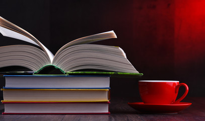 Composition with books and cup of coffee on the table