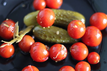 Marinated little cucumbers and tomatoes