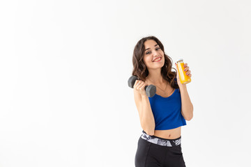Healthy lifestyle, people and sport concept - Woman with healthy juice drinking for sport and fitness on white background with copy space