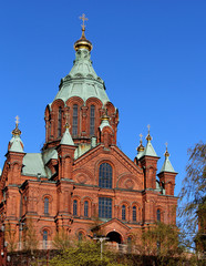 Fototapeta na wymiar Orthodox Uspenski Cathedral with red bricks and blue sky in spring in Helsinki