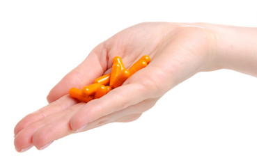 Pills capsules orange in hand medicine health on white background isolation
