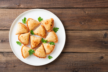 Vegetarian samosas filled with potato and green pea served with different sauces .Indian special traditional street food. 