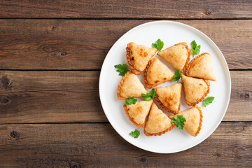 Vegetarian samosas filled with potato and green pea served with different sauces .Indian special traditional street food. 