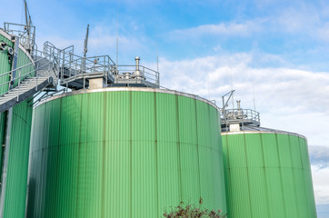 Biogas tanks of a biogas plant on blue sky background. Copy space.