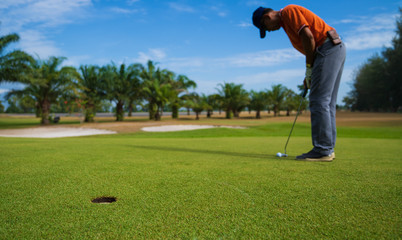 Golfer hitting golf shot with club on course vintage color tone, Man playing golf on a golf course in the sun, Golfers hit sweeping golf course in the summer