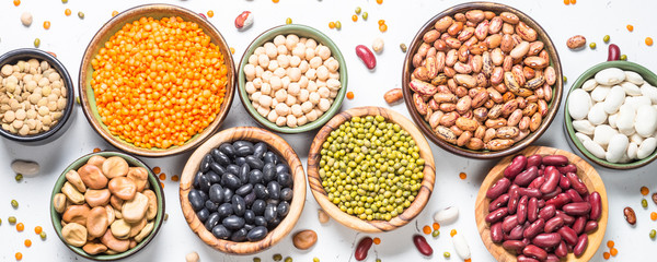 Legumes, lentils, chikpea and beans assortment on white.