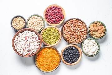 Obraz na płótnie Canvas Legumes, lentils, chikpea and beans assortment on white.
