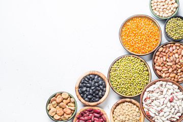 Legumes, lentils, chikpea and beans assortment on white.